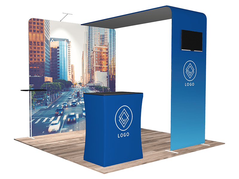 A blue trade show booth with a cityscape backdrop. The booth includes a counter and a large frame with a TV screen. The setup displays a logo featuring a geometric design.