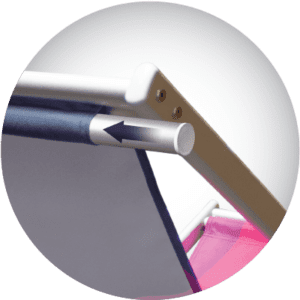 Close-up of a metal rod with a dark blue handle, featuring an arrow pointing to the left. The background includes parts of a white framework and a hint of pink fabric.