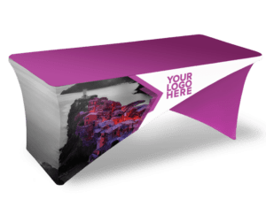 The Cross-Stretch Table Cover - Fully Printed is a fitted tablecloth in purple and white, featuring a placeholder for a logo and a design that includes an image of a coastal village on the side.