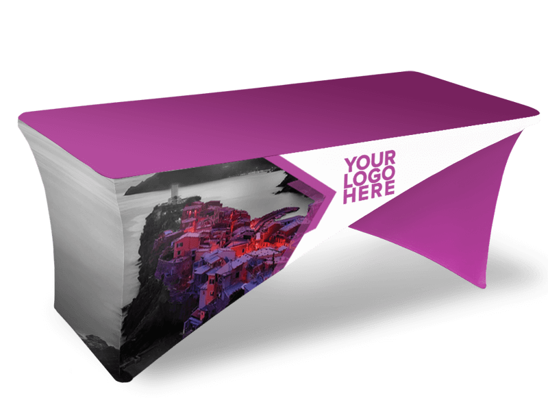 The Cross-Stretch Table Cover - Fully Printed is a fitted tablecloth in purple and white, featuring a placeholder for a logo and a design that includes an image of a coastal village on the side.