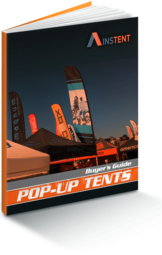 Cover of a Pop-Up Tents Buyers Guide featuring various branded 10 x 10 pop up canopy tents and flags set up outdoors against a clear blue sky.