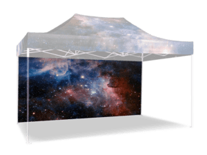 A 15' Printed Canopy Wall / Railskirt adorned with a cosmic galaxy print featuring stars and nebulae, set up outdoors.