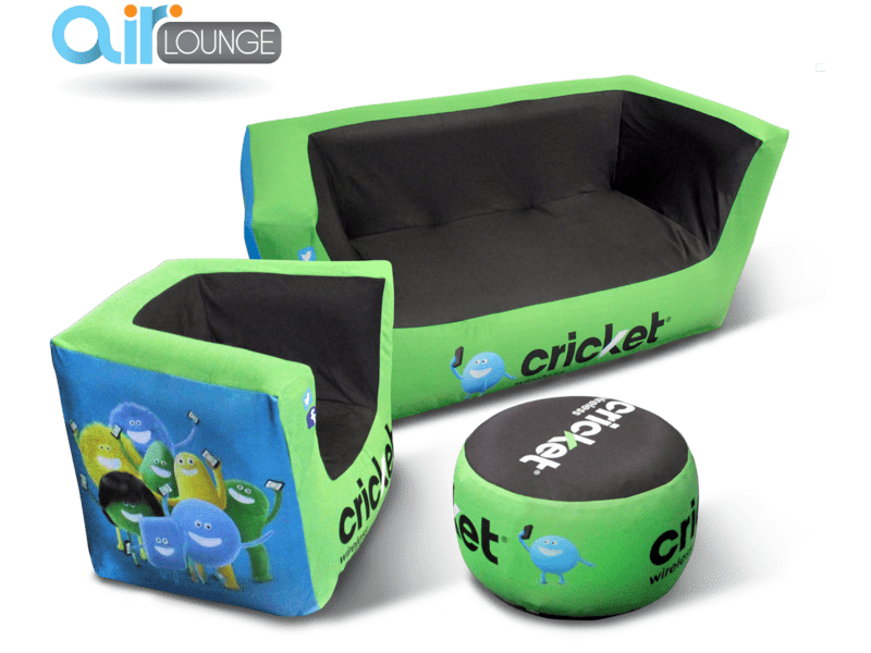 A green and black Custom Air'Lounge Inflatable Furniture Set featuring a sofa, chair, and round ottoman adorned with playful character graphics and cricket branding.