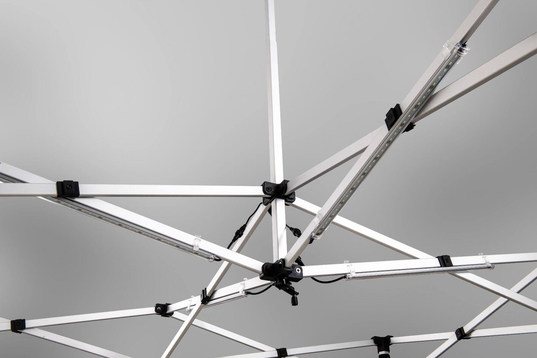 Close-up view of the LED Light Kit for Pop-Up Canopy, featuring an intricate gray and black metal framework structure, with attached LED light bars set against a light gray background.