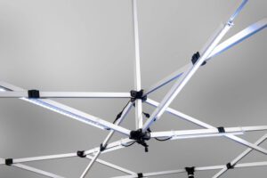 A close-up view of the LED Light Kit for Pop-Up Canopy, featuring a geometric framework of intersecting white beams with several LED light strips attached, set against a plain gray background.